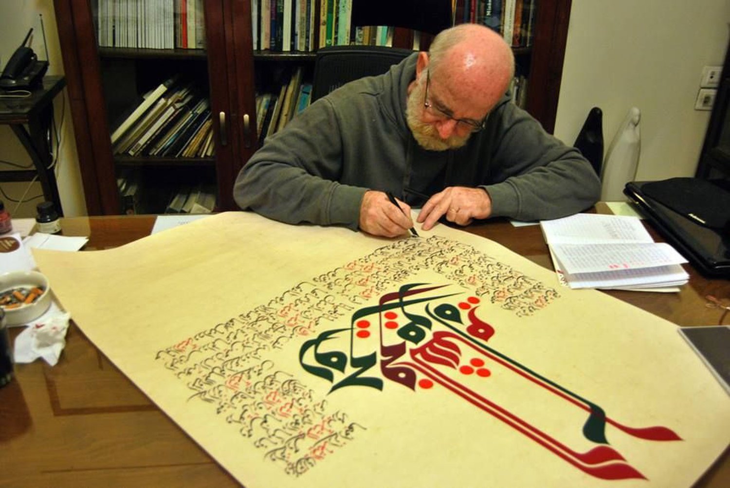 Syrian calligraphy artist Mouneer Al-Shaarani in the studio